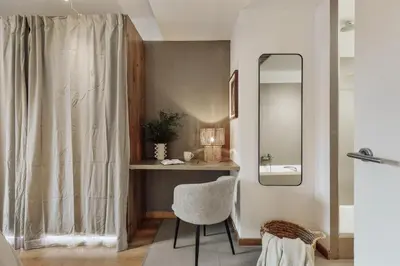 a hallway with a mirror and a black dresser at Bayal - 2 bedrooms and balcony in El Putxet in Barcelona