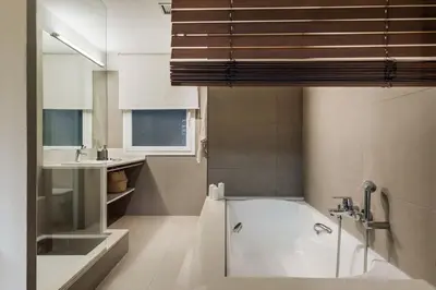 a bedroom with a large bed and a bathroom at Bayal - 2 bedrooms and balcony in El Putxet in Barcelona