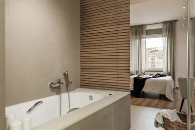 a bathroom with a bath tub and a bedroom at Bayal - 2 bedrooms and balcony in El Putxet in Barcelona