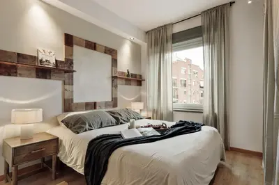 a living room with a white couch and a kitchen at Bayal - 2 bedrooms and balcony in El Putxet in Barcelona