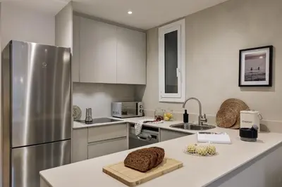 a bedroom with a bed and a desk with a laptop at Jabillos - 2 bedrooms and balcony in El Putxet in Barcelona