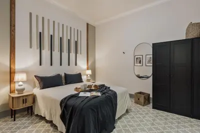 a bedroom with a bed with a large mirror at Kaftan - 5 bedrooms and balcony in Eixample Dreta in Barcelona