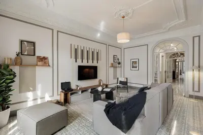 a living room with a desk and a table and chairs at Kaftan - 5 bedrooms and balcony in Eixample Dreta in Barcelona