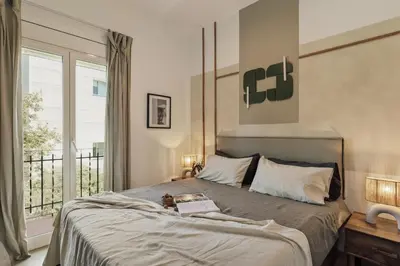 a bedroom with a bed with a book on it at Nampi - 2 bedrooms and balcony in El Poblenou in Barcelona