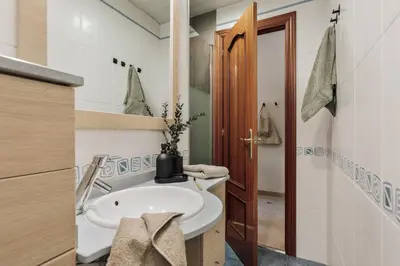 a bathroom with a white sink and a mirror at Nampi - 2 bedrooms and balcony in El Poblenou in Barcelona