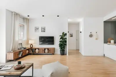 a white living room with a couch and a table at Ravello - 3 bedroom and terrace in Sant Gervasi in Barcelona