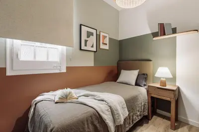 a bedroom with a bed with a book on it at Tulum - 3 bedrooms and balcony in Gràcia in Barcelona