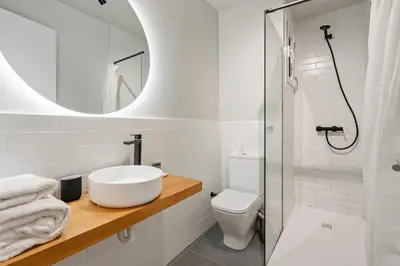 a bathroom with a sink and a toilet and a mirror at Flateli Espronceda 01 in Barcelona