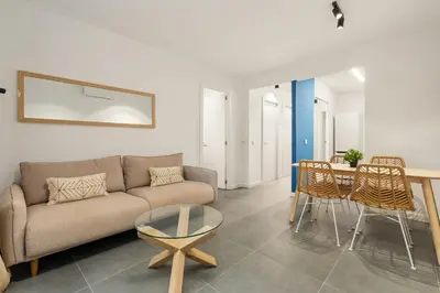 a living room with a couch and a table and chairs at Flateli Espronceda 11 in Barcelona