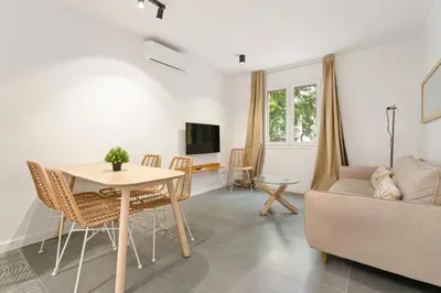 a living room with a table and a couch at Flateli Espronceda 22 in Barcelona