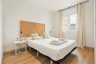 a bedroom with a bed and a table and a window at Flateli Espronceda 32 in Barcelona