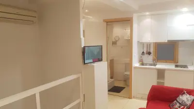 a living room with a television and a bathroom at 016 DUPLEX centric in Barcelona