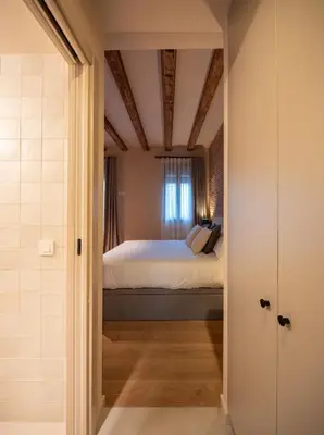 a bathroom with a walk in shower and a coat hanging on the wall at Casa Badajoz in Barcelona