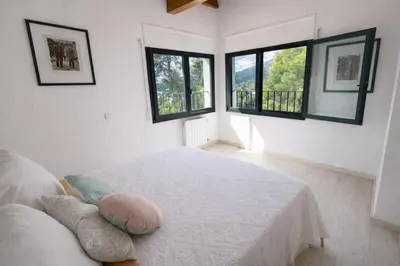 a white room with a bed and two windows at Sun & Sand Sanctuary - 2km to beach and 20km BCN! in Castelldefels