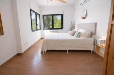a bedroom with a bed and two windows at Sun & Sand Sanctuary - 2km to beach and 20km BCN! in Castelldefels
