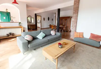 a living room with a couch and a coffee table at Sun & Sand Sanctuary - 2km to beach and 20km BCN! in Castelldefels