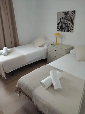a bedroom with two beds with white towels on them at Casa Vella de Casa Torrent in Canet de Mar