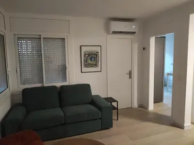 a living room with a green couch in a room at Casa Vella de Casa Torrent in Canet de Mar