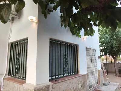 a gate on the side of a building at Casa Vella de Casa Torrent in Canet de Mar