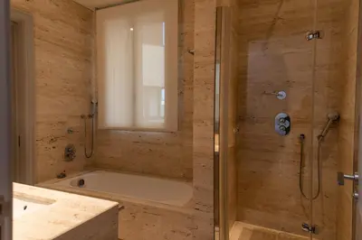 a bathroom with a shower and a bath tub at Paseo de Gracia Icon Apartment in Barcelona