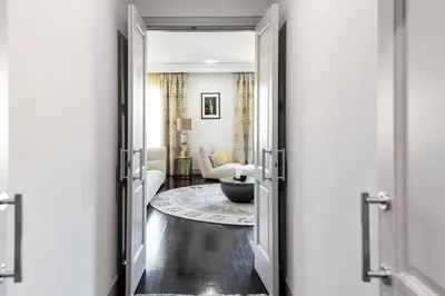 an open door into a living room with a couch at Paseo de Gracia Icon Apartment in Barcelona