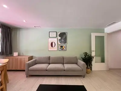 a living room with a couch in a room at Stay U-nique Apartment Roma in Barcelona