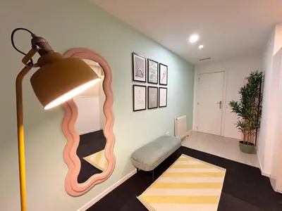a living room with a lamp and a mirror on the wall at Stay U-nique Apartment Roma in Barcelona