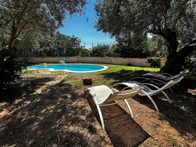 a group of chairs sitting next to a swimming pool at Maset del Garraf in Olesa de Bonesvalls