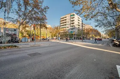 an empty street in a city with a tall building at Stay U-nique Tapioles Central Apartment in Barcelona