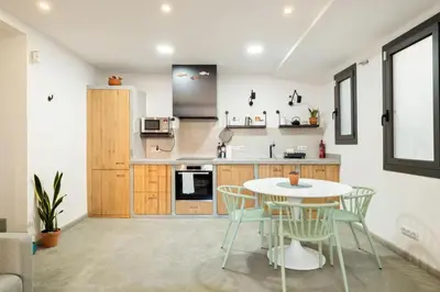 a kitchen with a table and chairs in a room at Stay U-nique Tapioles Central Apartment in Barcelona