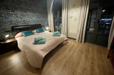 a bedroom with a bed with two pillows on it at Apartamento de lujo a pie de metro in Terrassa