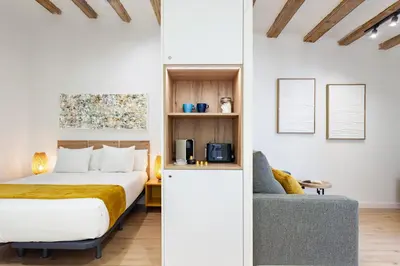 a hotel room with a bed and a chair at Art House Travessera de Gràcia-2 in Barcelona