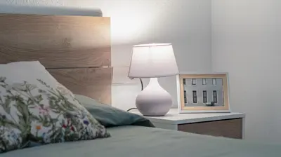 a lamp on a night stand next to a bed at Can Davilas Rustic Mountain House in Monistrol de Calders