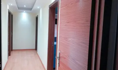 a wooden door in a room with a corridor at La Casa de Vacaciones in Terrassa