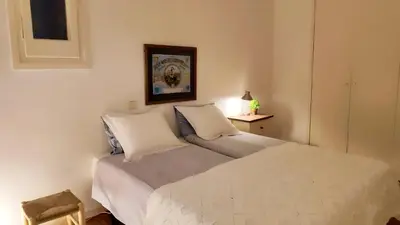 a bedroom with a bed with white sheets and pillows at Rambla-Plça Catalunya 2BR monthly stays -R.H in Barcelona
