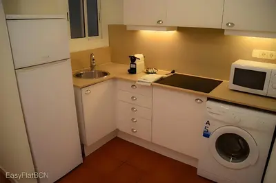 a living room with a table and chairs and a television at Rambla-Plça Catalunya 2BR monthly stays -R.H in Barcelona