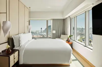 a large white bed in a room with windows at Hotel Arts Barcelona in Barcelona