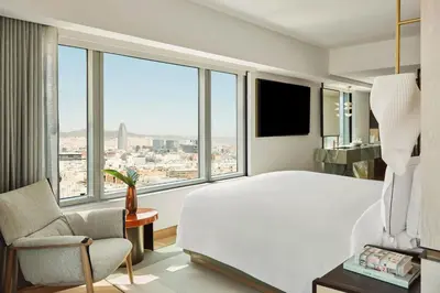 a bedroom with a large bed and a large window at Hotel Arts Barcelona in Barcelona