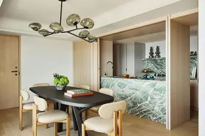 a kitchen and dining room with a black table and chairs at Hotel Arts Barcelona in Barcelona