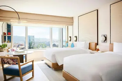 a hotel room with two beds and a window at Hotel Arts Barcelona in Barcelona