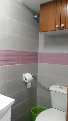 a bathroom with a toilet and a toilet paper dispenser at Coliving 87 estudio numero 10 in Barcelona