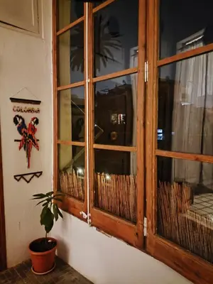 a wooden window in a room with a potted plant at Habitación grande con balcón y mucha luz in Barcelona