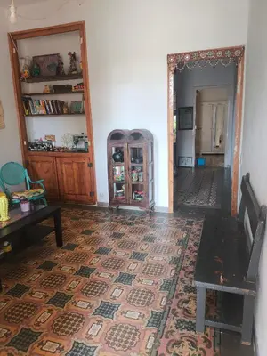 a living room with a table and a rug at Habitación grande con balcón y mucha luz in Barcelona