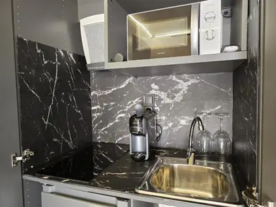 a kitchen counter with a sink and a microwave at Costa Dorada Tiny Amaia in Canet de Mar