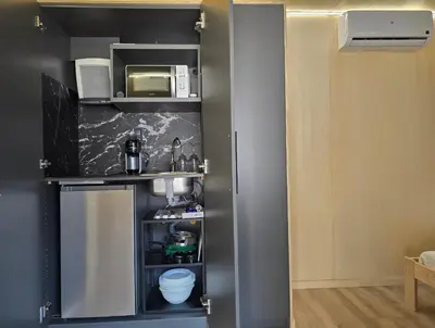a small kitchen with a sink and a microwave at Costa Dorada Tiny Amaia in Canet de Mar