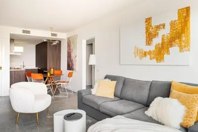 a living room with a gray couch and a table at SeaSunSand Apartment in San Pol de Mar