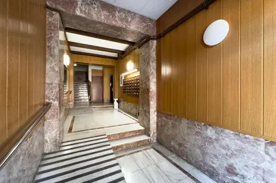 a hallway in a building with wooden walls and stairs at Furnished & Fully Equipped 2BR near the beach in Barcelona