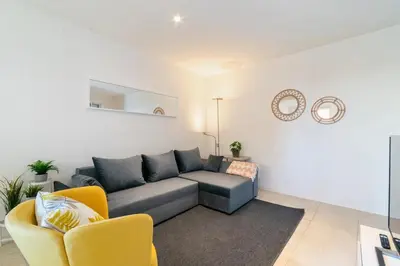 a living room with a couch and two chairs at Furnished & Fully Equipped 2BR near the beach in Barcelona