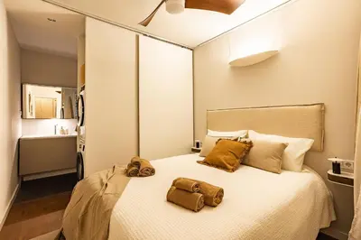 a bedroom with a bed with two bags on it at Cozy Apartment in Barcelona in Barcelona