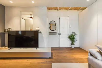 a living room with a large flat screen tv at Cozy Apartment in Barcelona in Barcelona